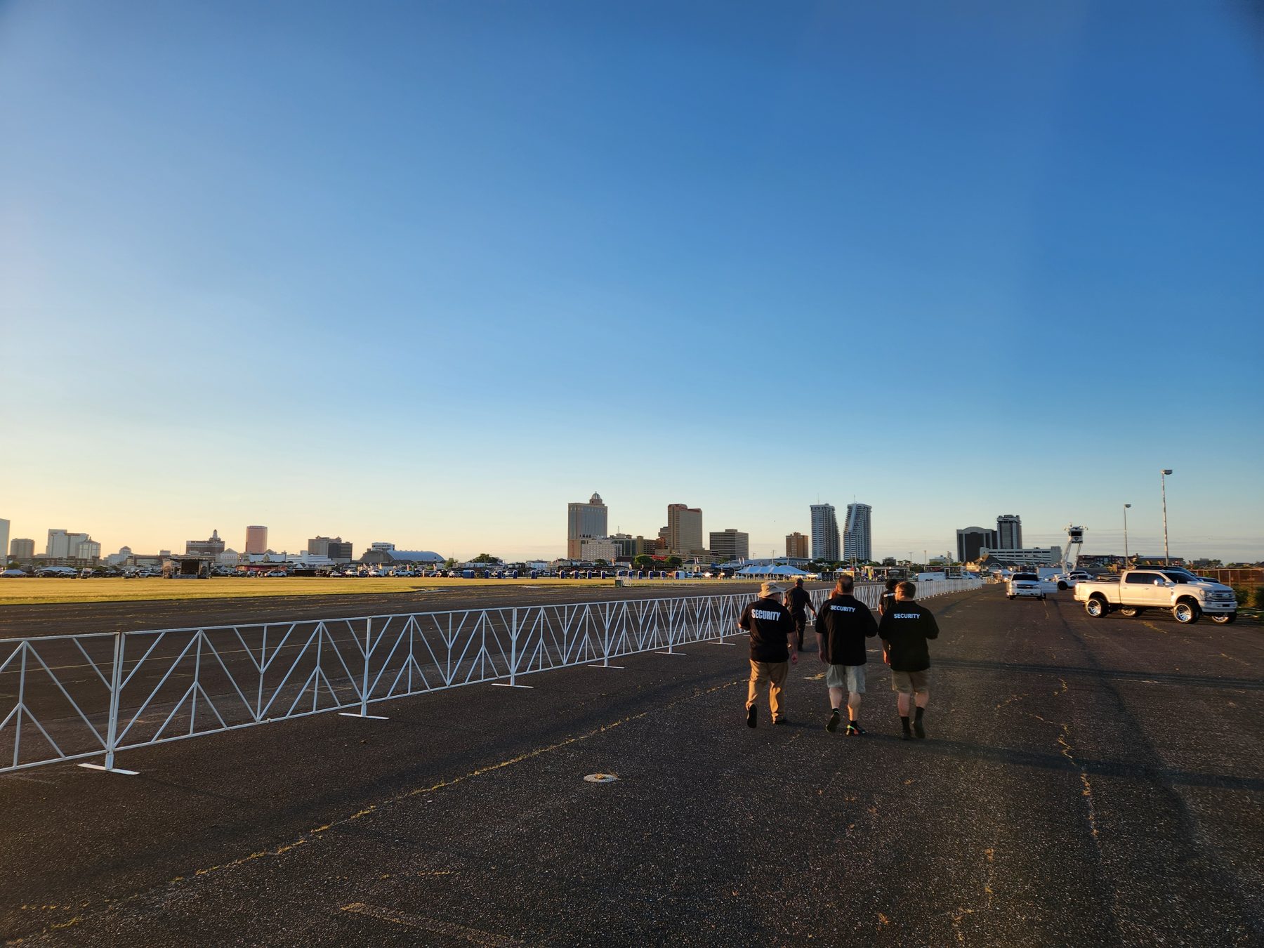 Semper Secure officers walking the Atlantic City truck show at Bader Field with the Atlantic City skyline behind them