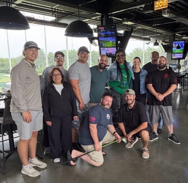 Semper Secure team members at a company outing at Topgolf