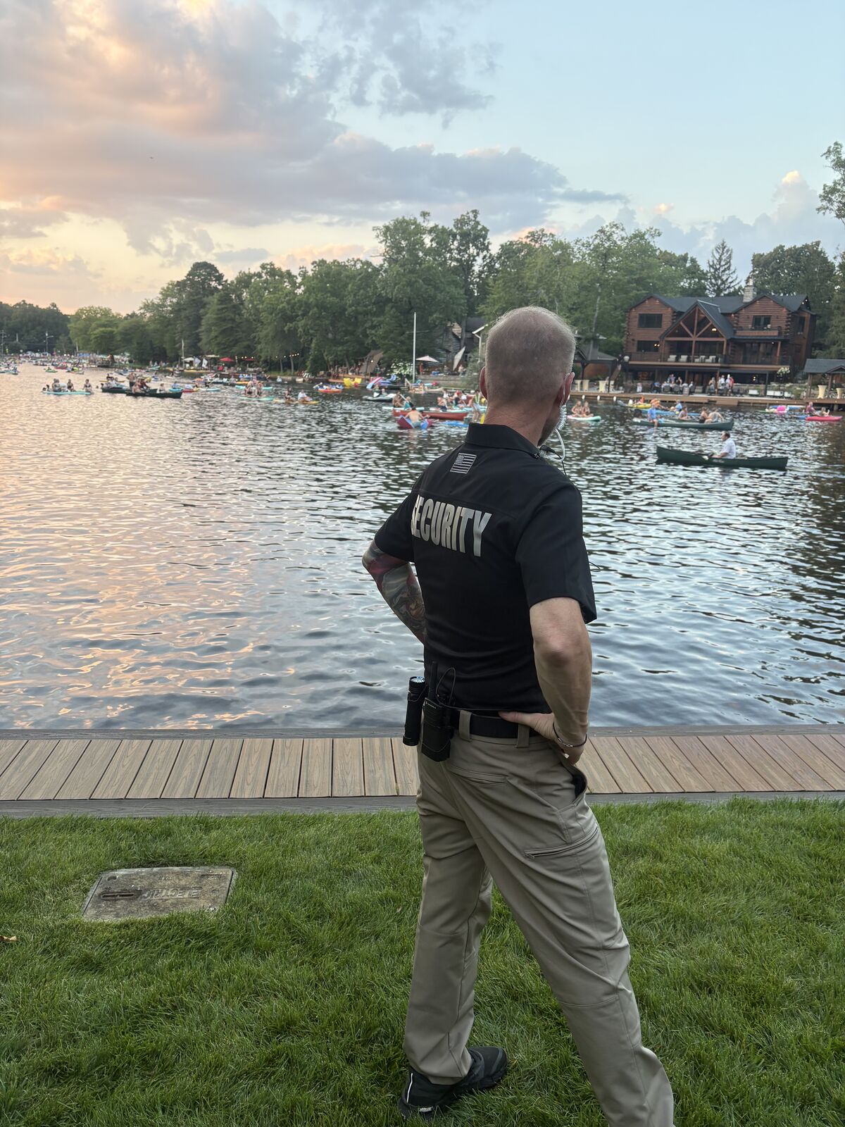 Semper Secure officer watching over a lakefront event at sunset